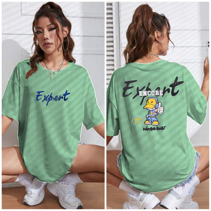 Back view of woman wearing oversized lavender “Expert Encore” cartoon t-shirt