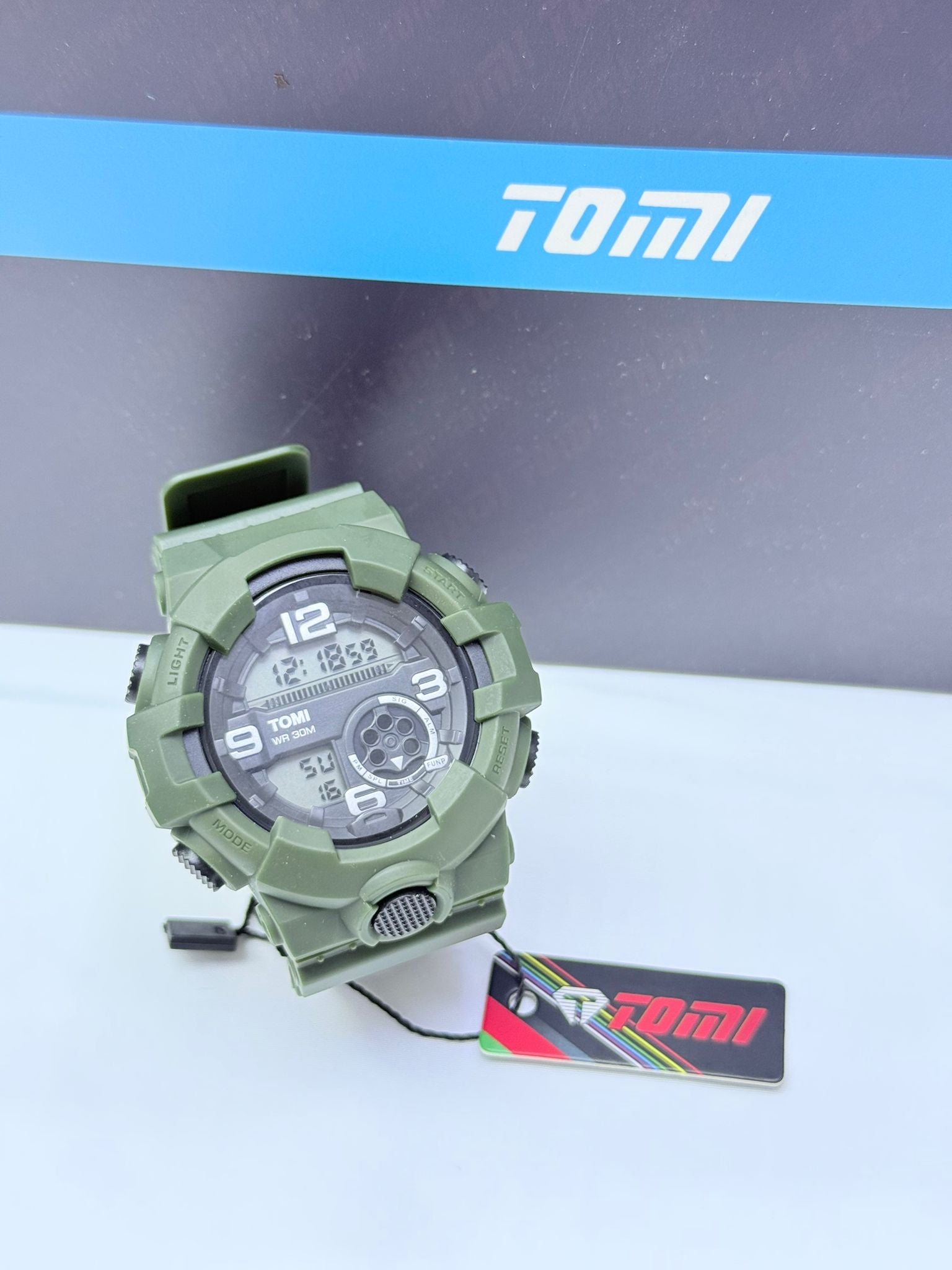 Army green Tomi sports digital analog wristwatch with rugged military design.