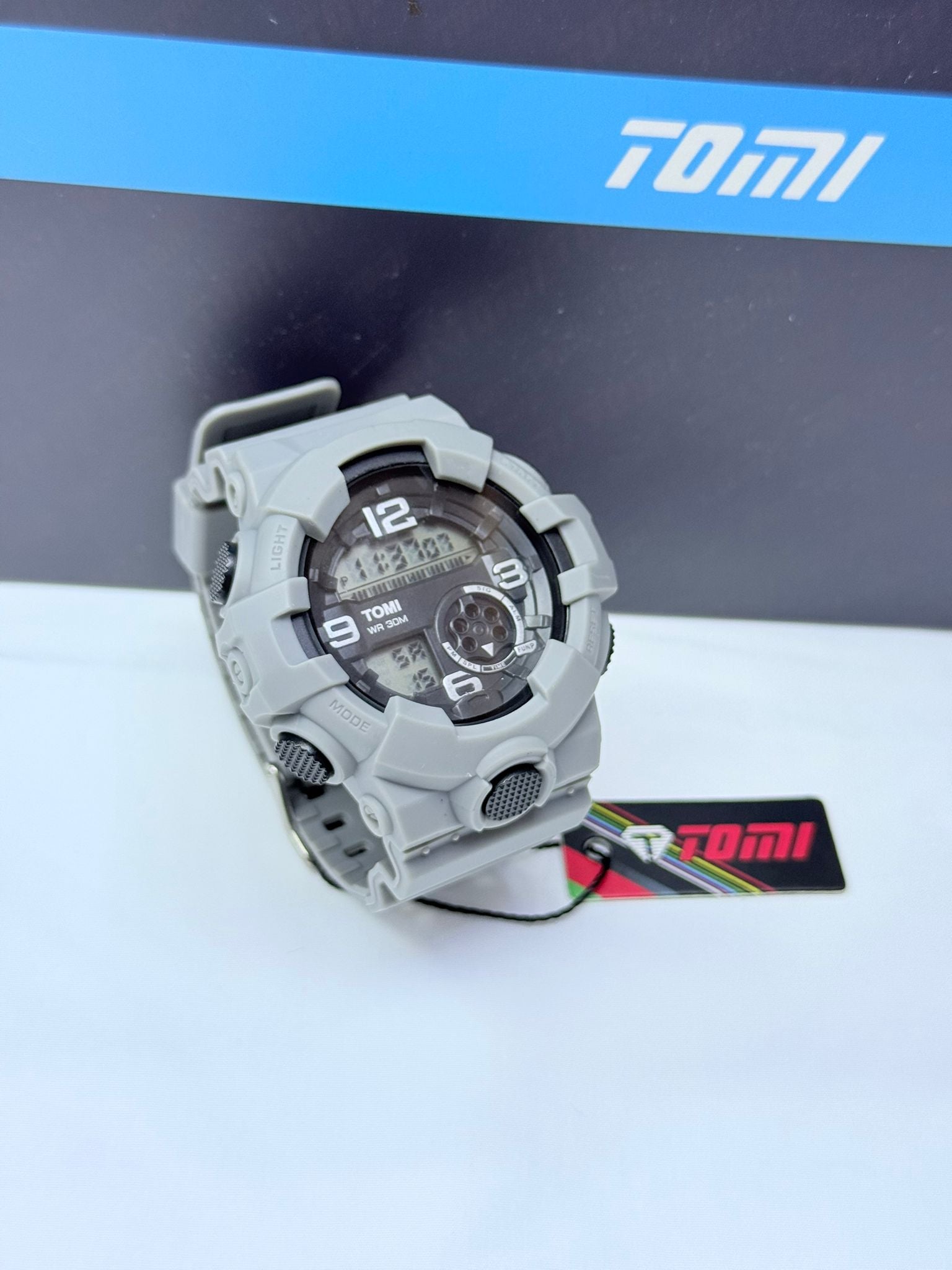 Grey Tomi digital analog sports wristwatch with rugged design.