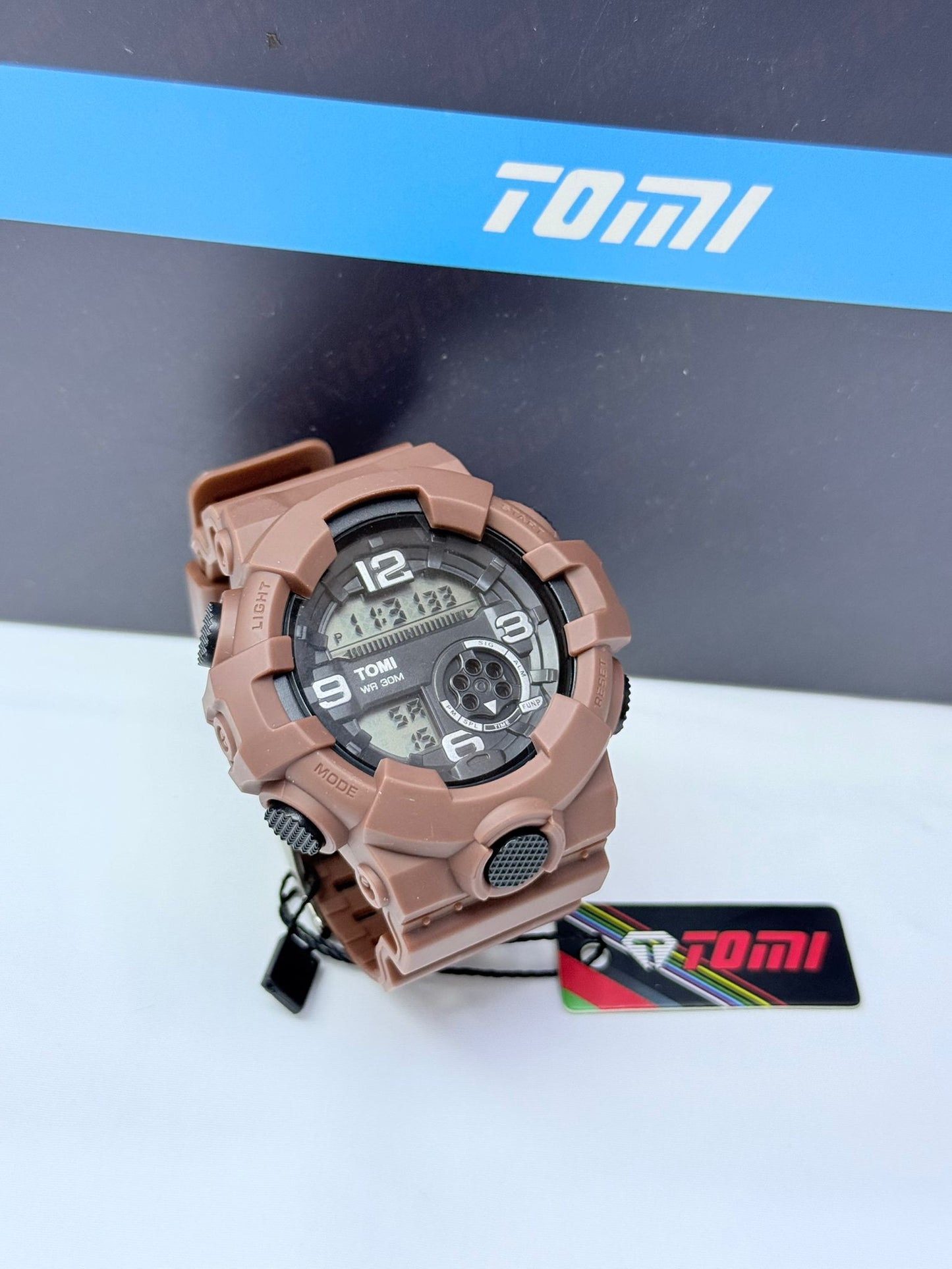 Brown Tomi digital analog sports wristwatch with rugged durable design.